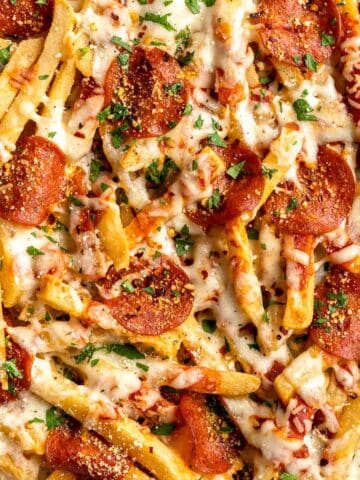 Baked Pizza Fries are loaded with a rich marinara sauce, melted cheese, and crispy pepperoni — transforming ordinary fries into the ultimate finger food. | aheadofthyme.com