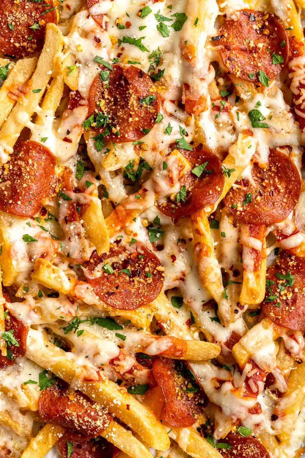 Baked Pizza Fries are loaded with a rich marinara sauce, melted cheese, and crispy pepperoni — transforming ordinary fries into the ultimate finger food. | aheadofthyme.com