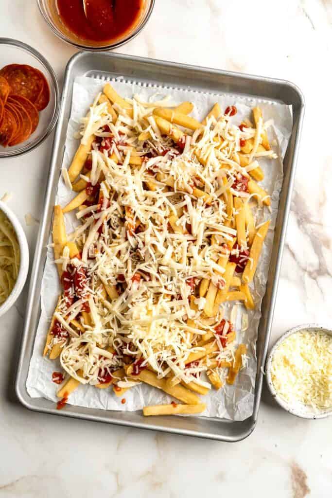 Baked Pizza Fries are loaded with a rich marinara sauce, melted cheese, and crispy pepperoni — transforming ordinary fries into the ultimate finger food. | aheadofthyme.com