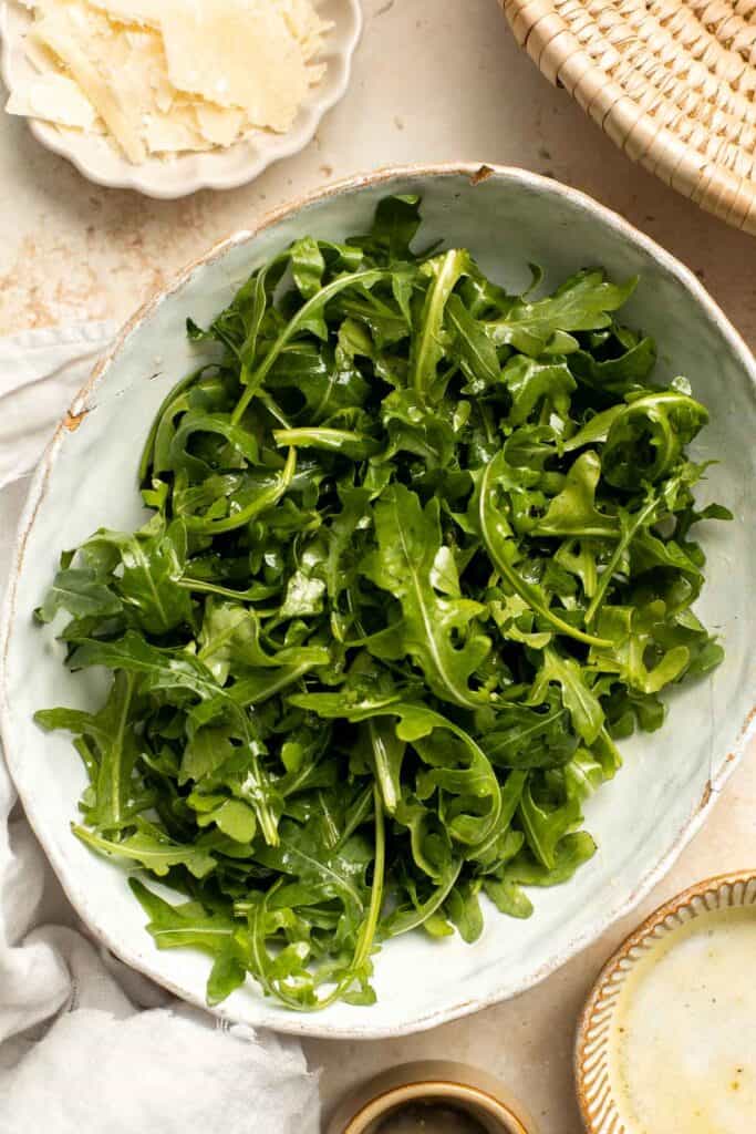 Arugula Salad with Parmesan cheese and a simple homemade lemon dressing is healthy, fresh, and delicious. Toss it together in just 5 minutes! | aheadofthyme.com