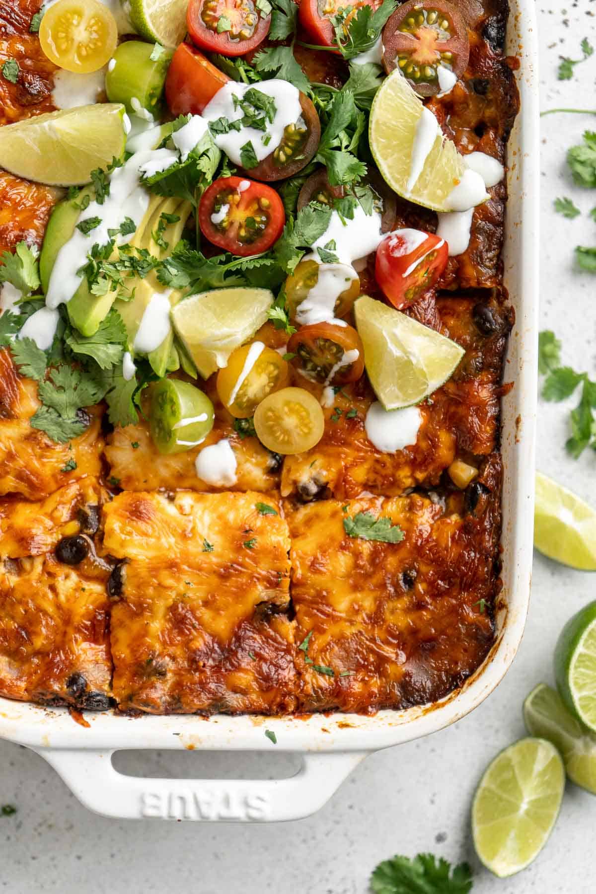 Chicken Enchilada Casserole is cheesy, saucy, and packed with layers of enchilada classics like chicken and beans, tortillas, and cheese. A family favorite! | aheadofthyme.com