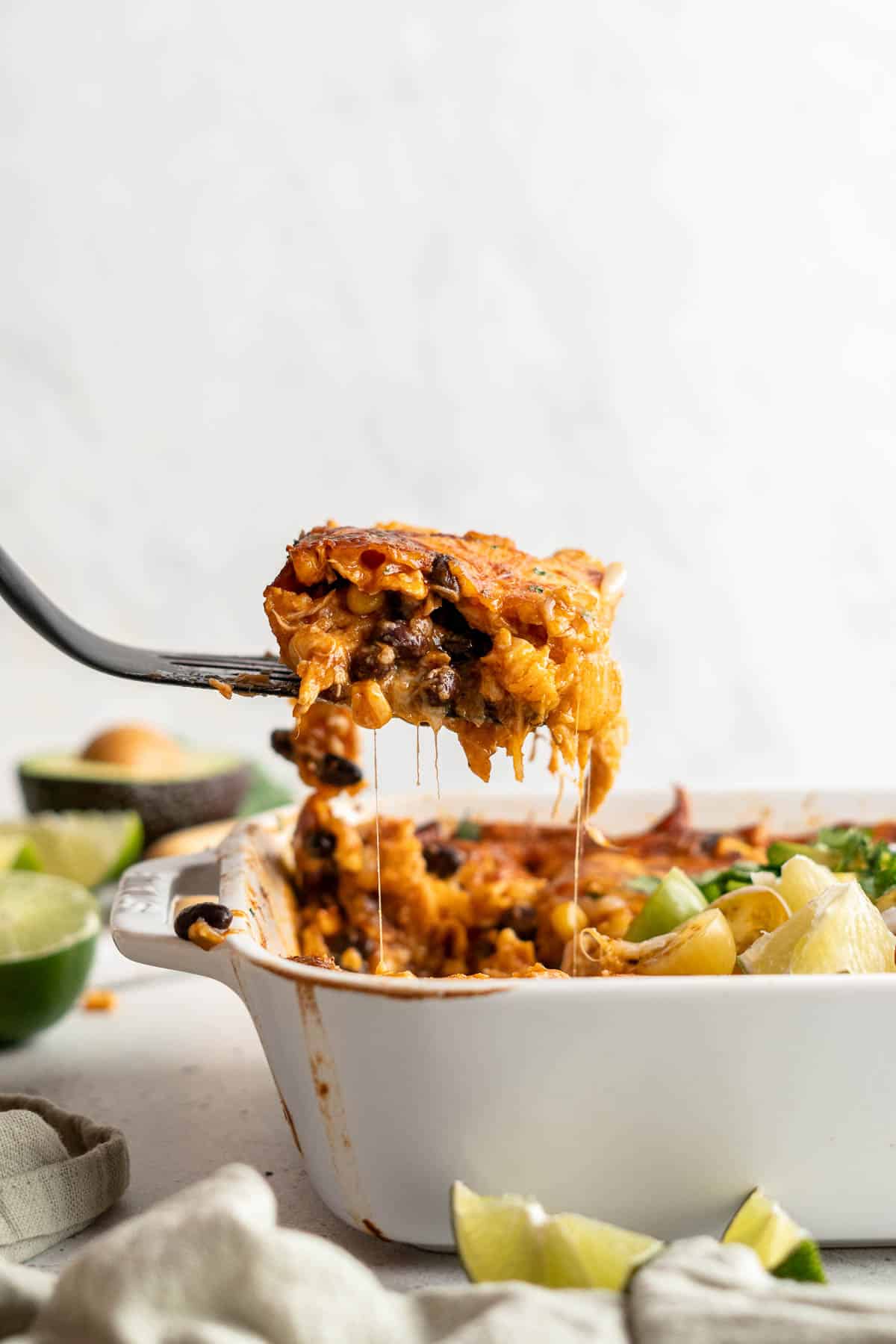 Chicken Enchilada Casserole is cheesy, saucy, and packed with layers of enchilada classics like chicken and beans, tortillas, and cheese. A family favorite! | aheadofthyme.com