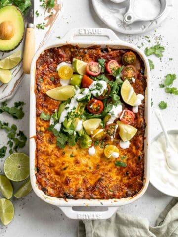 Chicken Enchilada Casserole is cheesy, saucy, and packed with layers of enchilada classics like chicken and beans, tortillas, and cheese. A family favorite! | aheadofthyme.com