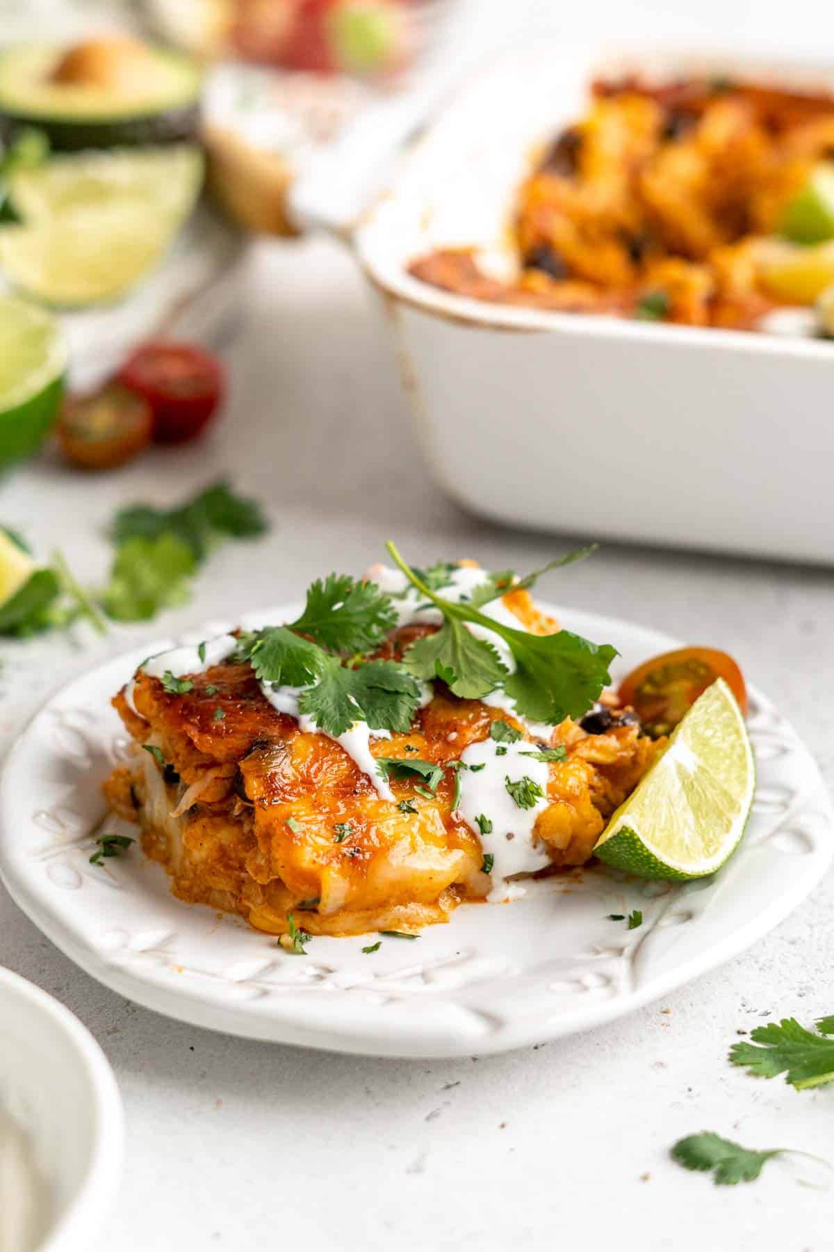 Chicken Enchilada Casserole is cheesy, saucy, and packed with layers of enchilada classics like chicken and beans, tortillas, and cheese. A family favorite! | aheadofthyme.com