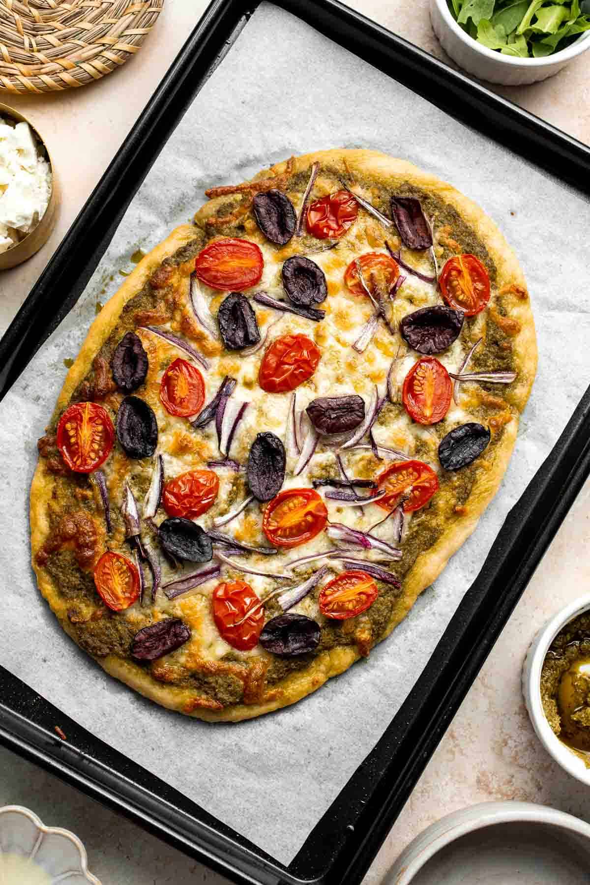 Mediterranean Flatbread is a zesty and cheesy vegetarian pizza, loaded with classic Mediterranean ingredients. It is quick and easy to make in 20 minutes. | aheadofthyme.com