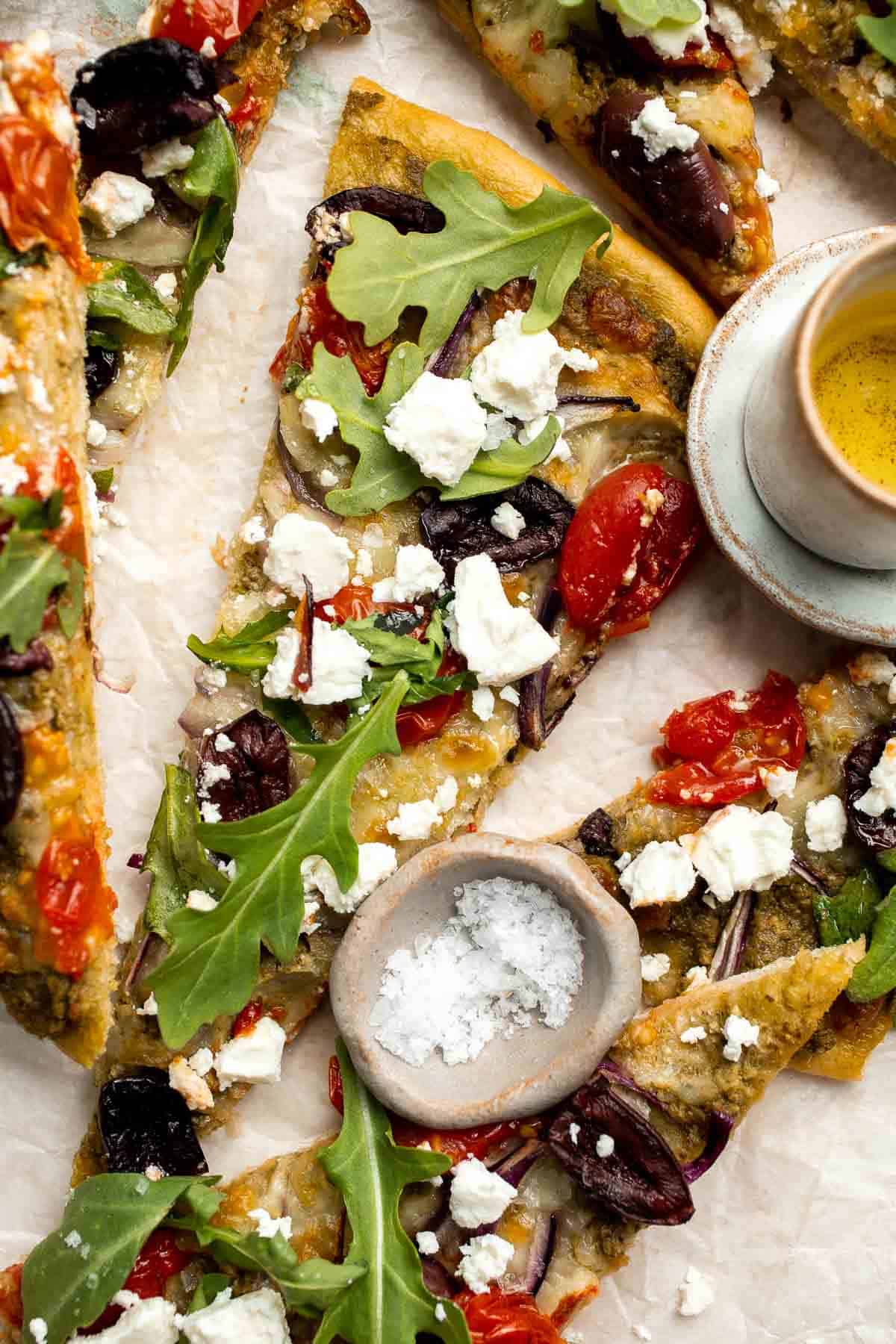 Mediterranean Flatbread is a zesty and cheesy vegetarian pizza, loaded with classic Mediterranean ingredients. It is quick and easy to make in 20 minutes. | aheadofthyme.com