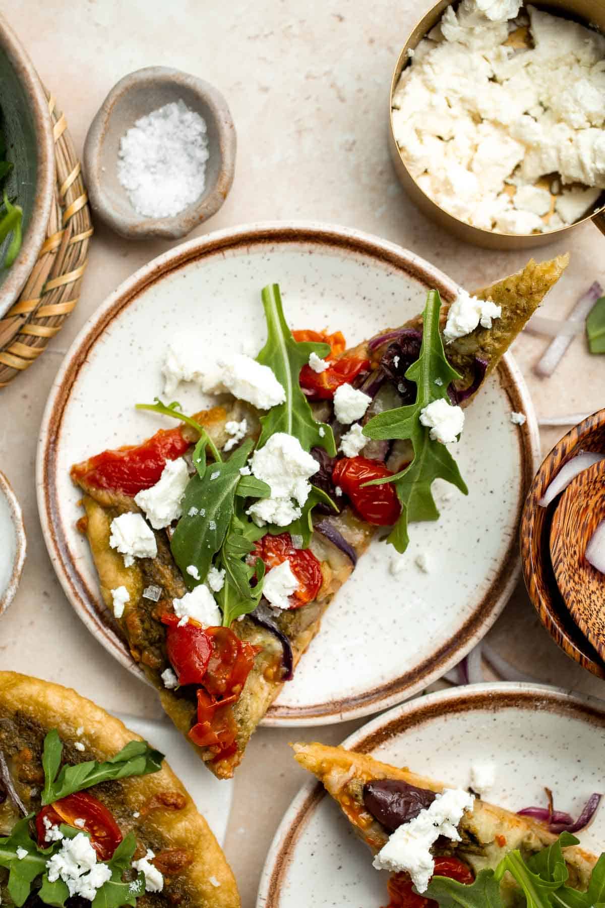 Mediterranean Flatbread is a zesty and cheesy vegetarian pizza, loaded with classic Mediterranean ingredients. It is quick and easy to make in 20 minutes. | aheadofthyme.com