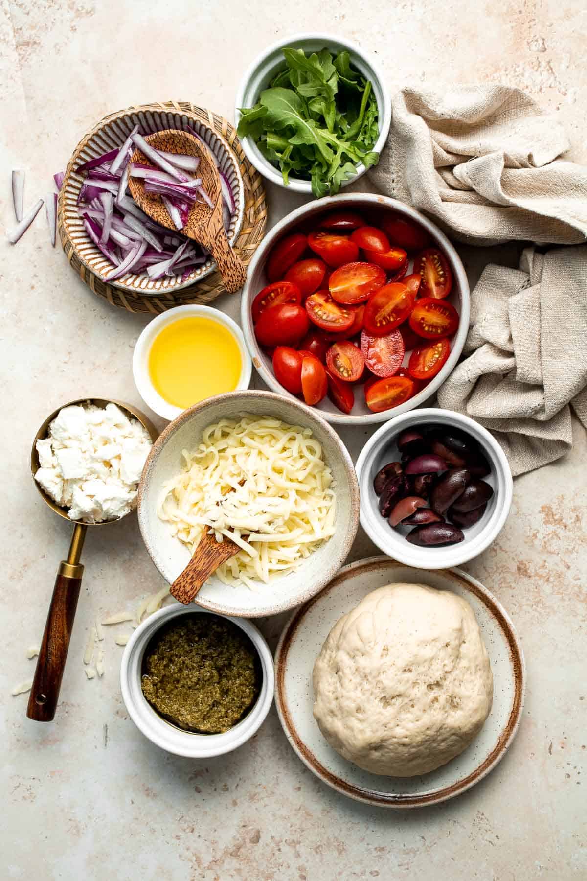 Mediterranean Flatbread is a zesty and cheesy vegetarian pizza, loaded with classic Mediterranean ingredients. It is quick and easy to make in 20 minutes. | aheadofthyme.com