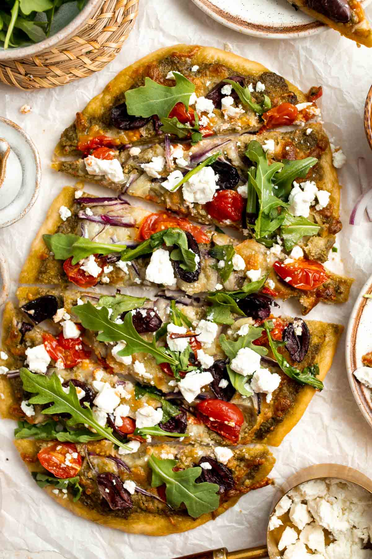 Mediterranean Flatbread is a zesty and cheesy vegetarian pizza, loaded with classic Mediterranean ingredients. It is quick and easy to make in 20 minutes. | aheadofthyme.com