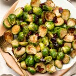 Brussels Sprouts with Cranberries are a delicious, festive side dish that is easy to make with earthy Brussels sprouts and tart cranberries. | aheadofthyme.com
