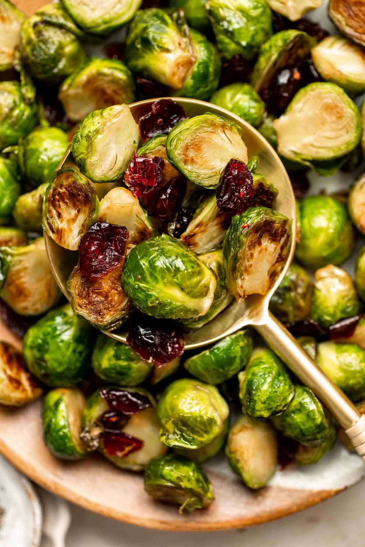 Brussels Sprouts with Cranberries are a delicious, festive side dish that is easy to make with earthy Brussels sprouts and tart cranberries. | aheadofthyme.com