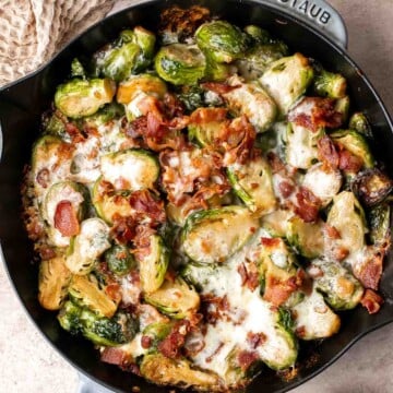 Cheesy Brussels Sprouts Bake is a comforting side dish made with sautéed garlic brussels sprouts, topped with bacon and cheese, and baked until bubbly. | aheadofthyme.com