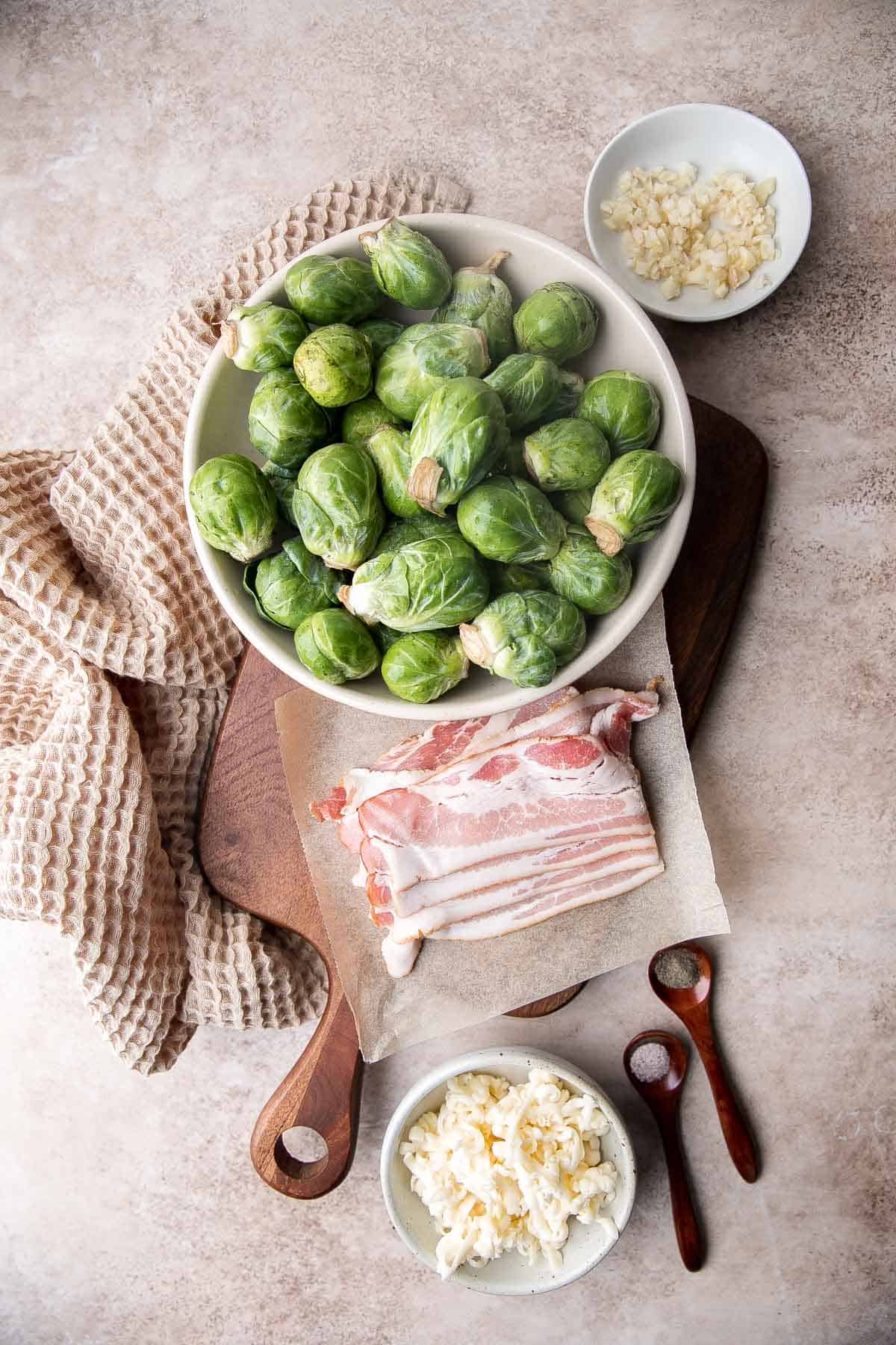 Cheesy Brussels Sprouts Bake is a comforting side dish made with sautéed garlic brussels sprouts, topped with bacon and cheese, and baked until bubbly. | aheadofthyme.com