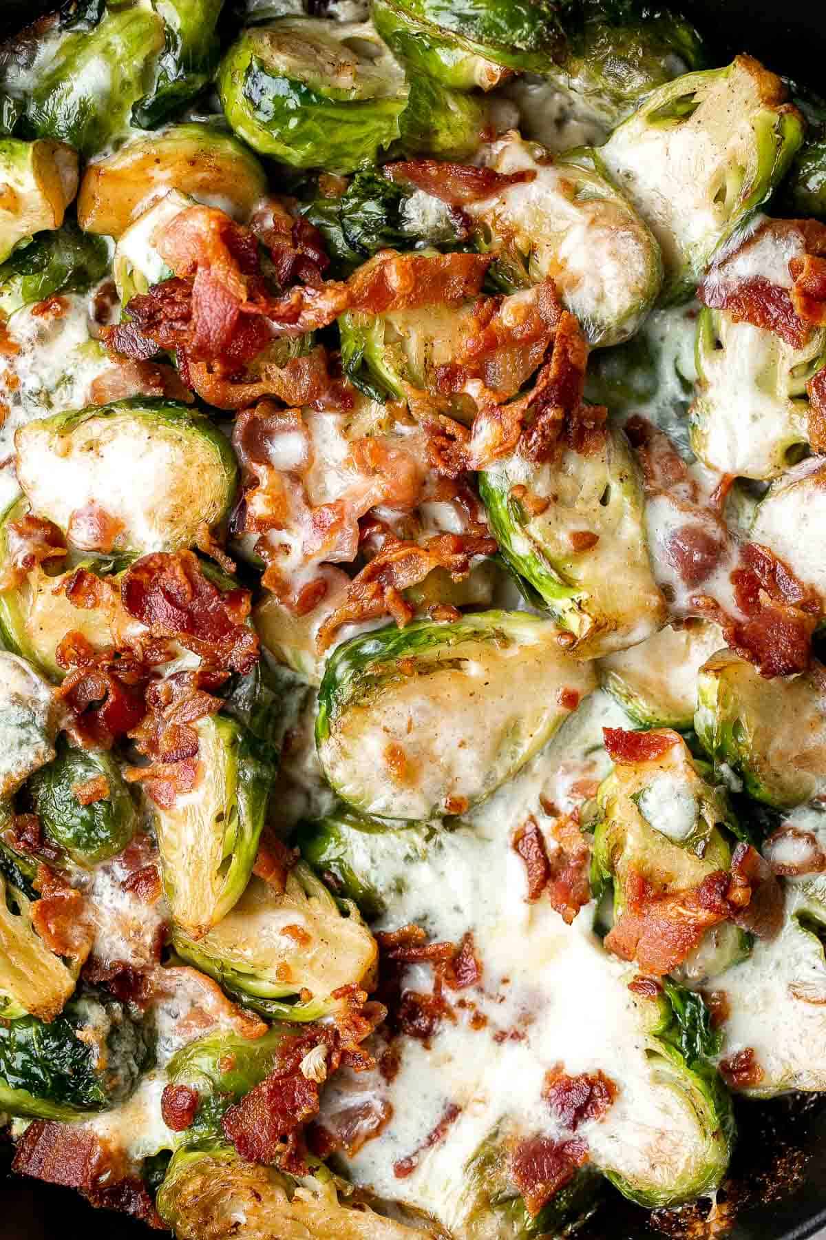 Cheesy Brussels Sprouts Bake is a comforting side dish made with sautéed garlic brussels sprouts, topped with bacon and cheese, and baked until bubbly. | aheadofthyme.com
