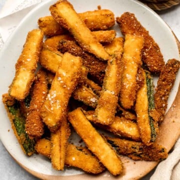 Fried Zucchini are flavorful, savory, and delicious. Soft and tender zucchini fries are coated in a golden crispy breadcrumb exterior. So good! | aheadofthyme.com