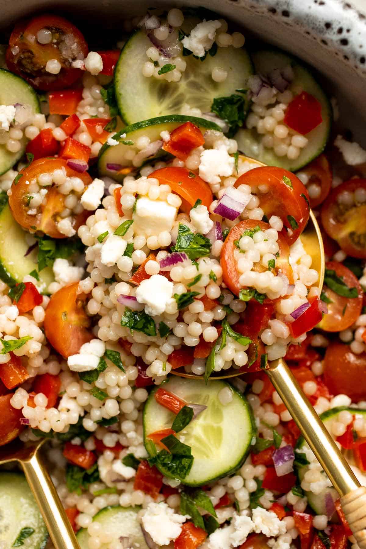 Israeli Couscous Salad is a hearty, flavorful, and delicious salad, packed with pearl couscous, fresh veggies, and feta, tossed in a simple lemon dressing. | aheadofthyme.com