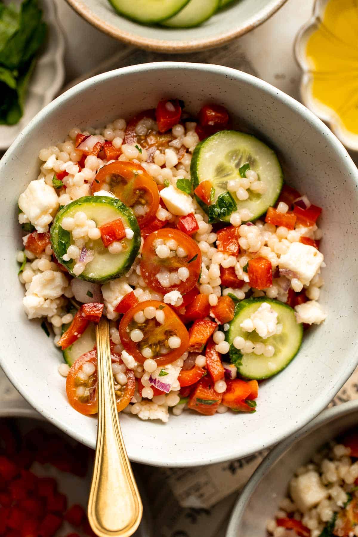 Israeli Couscous Salad is a hearty, flavorful, and delicious salad, packed with pearl couscous, fresh veggies, and feta, tossed in a simple lemon dressing. | aheadofthyme.com