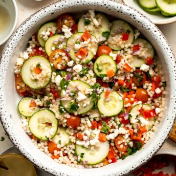 Israeli Couscous Salad is a hearty, flavorful, and delicious salad, packed with pearl couscous, fresh veggies, and feta, tossed in a simple lemon dressing. | aheadofthyme.com