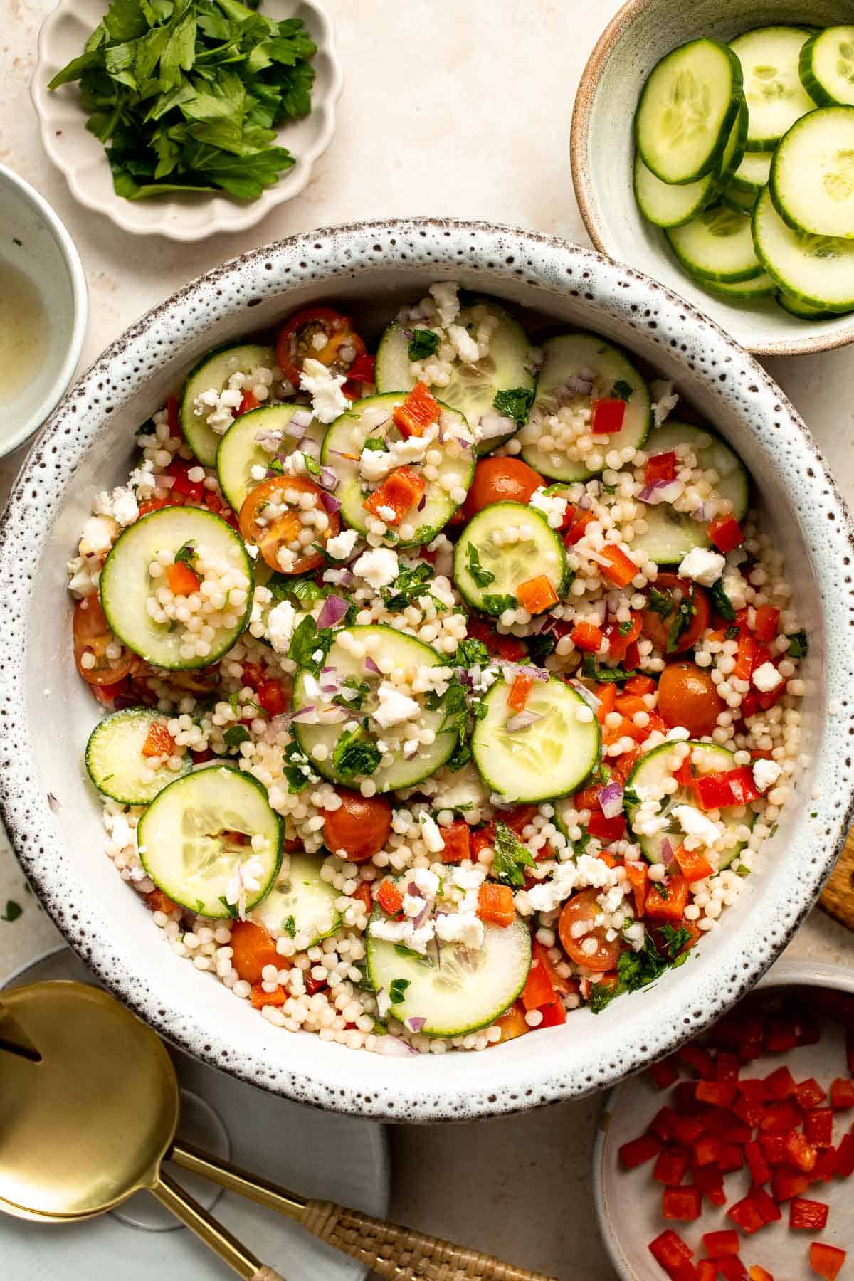 Israeli Couscous Salad is a hearty, flavorful, and delicious salad, packed with pearl couscous, fresh veggies, and feta, tossed in a simple lemon dressing. | aheadofthyme.com