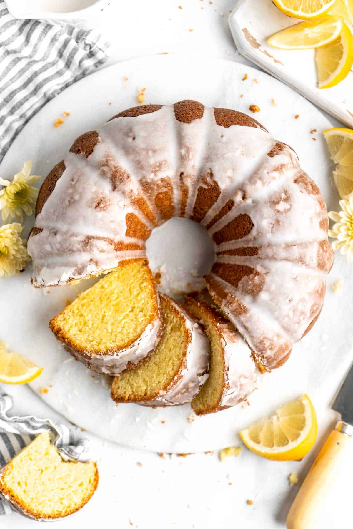 Lemon Bundt Cake with a sweet vanilla glaze is light, fluffy, and moist with a perfect golden brown crumb and made with real lemons. | aheadofthyme.com
