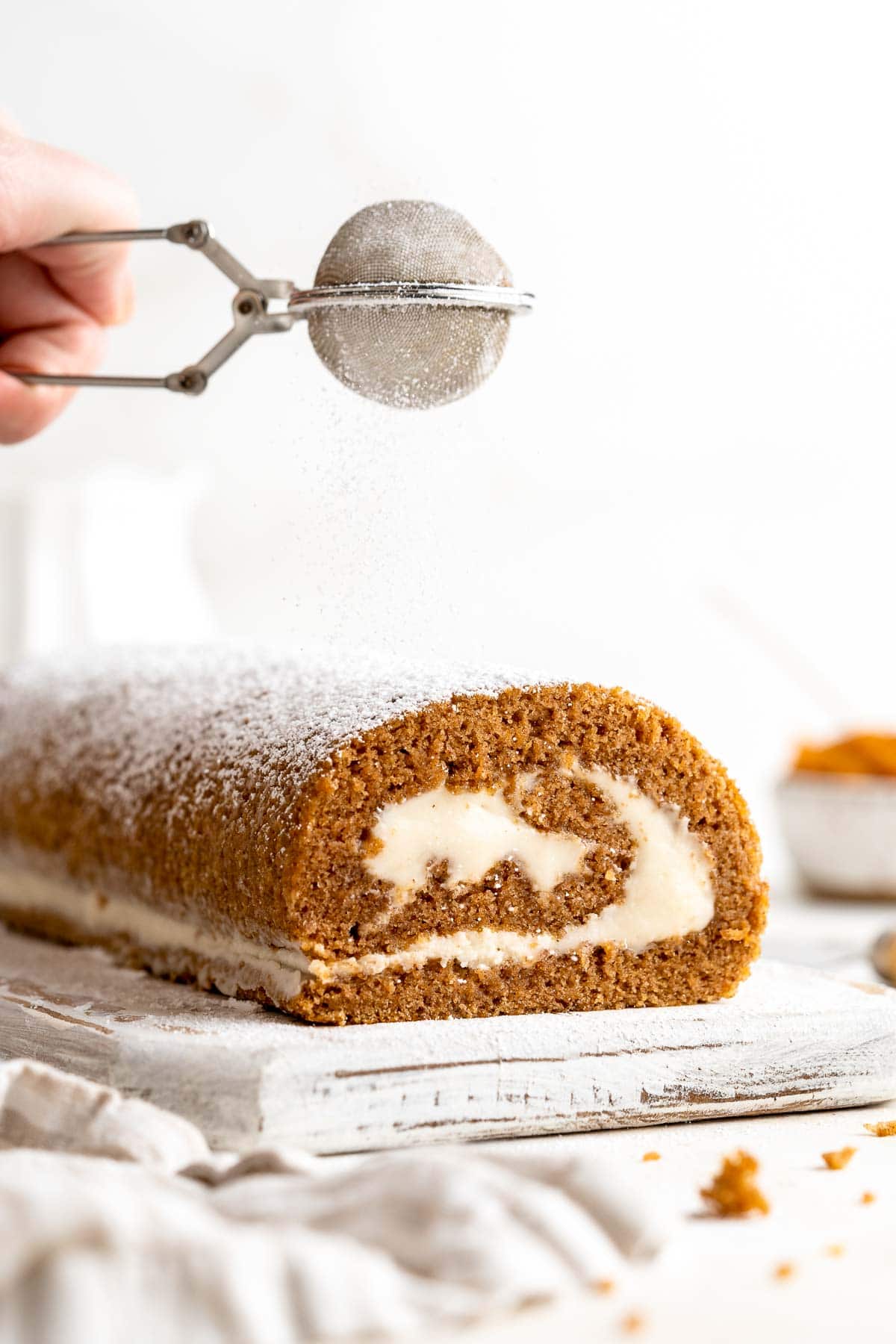 Celebrate the flavors of fall with a show-stopping Pumpkin Roll featuring a tender pumpkin spice cake swirled around a rich cream cheese filling. | aheadofthyme.com