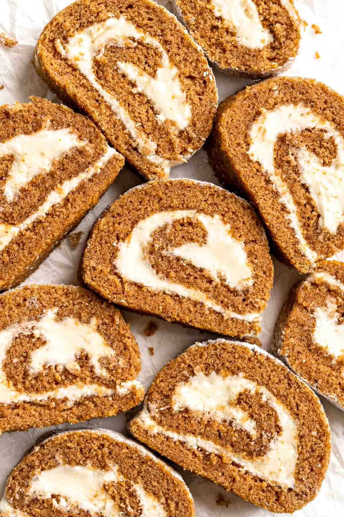 Celebrate the flavors of fall with a show-stopping Pumpkin Roll featuring a tender pumpkin spice cake swirled around a rich cream cheese filling. | aheadofthyme.com