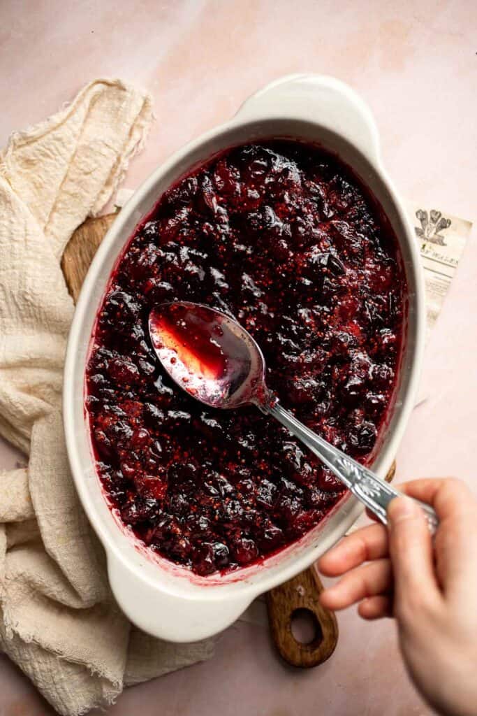 This Baked Cranberry Sauce recipe is an easy way to make a classic Thanksgiving side dish in the oven using 4 ingredients. It is thick, tart, and sweet. | aheadofthyme.com