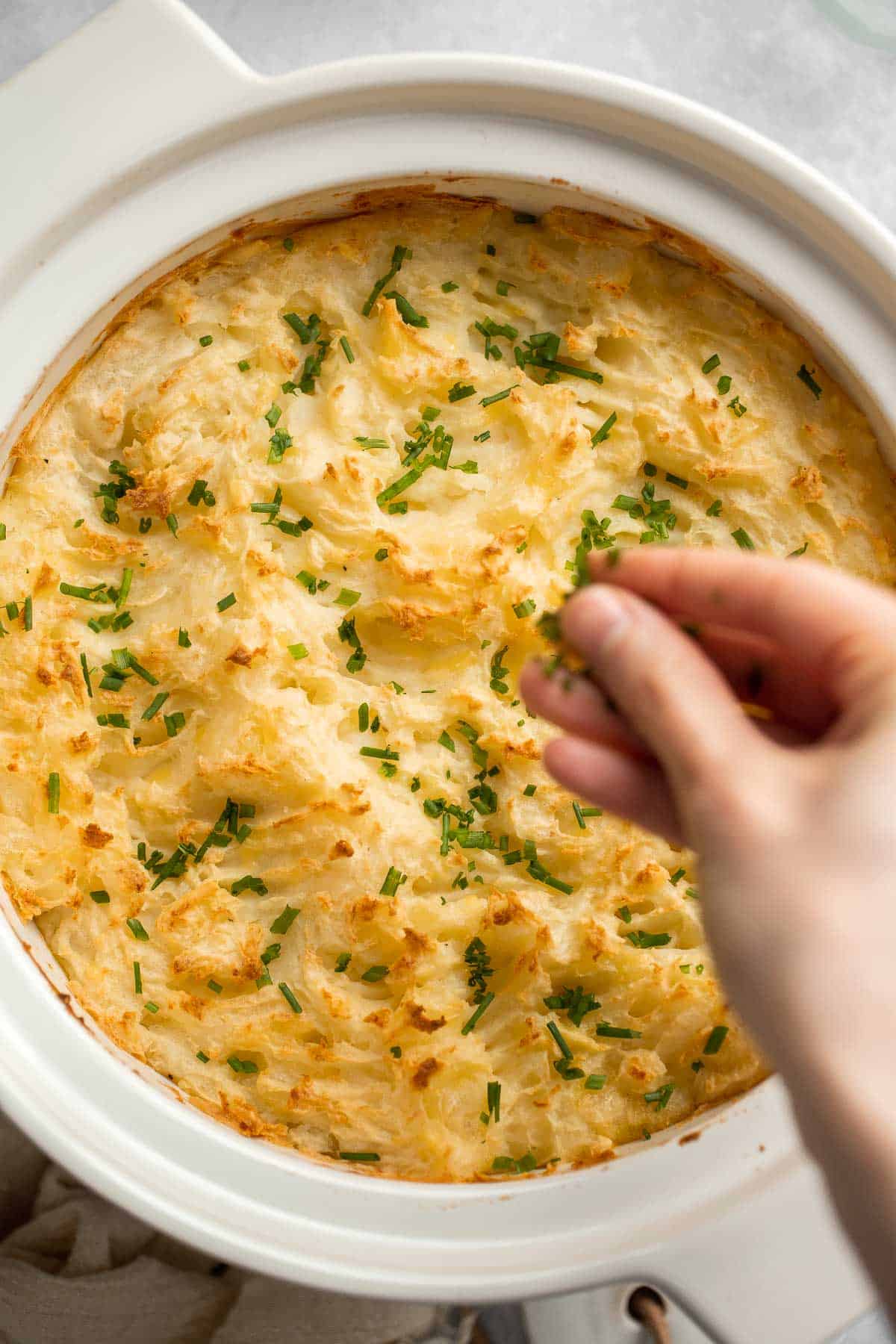 Baked Mashed Potatoes are buttery, cheesy, and crispy on the outside. Topped with chives and served warm, this side dish that will change your hosting game. | aheadofthyme.com