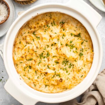 Baked Mashed Potatoes are buttery, cheesy, and crispy on the outside. Topped with chives and served warm, this side dish that will change your hosting game. | aheadofthyme.com