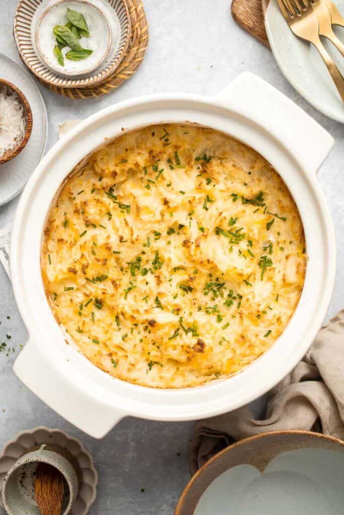 Baked Mashed Potatoes are buttery, cheesy, and crispy on the outside. Topped with chives and served warm, this side dish that will change your hosting game. | aheadofthyme.com