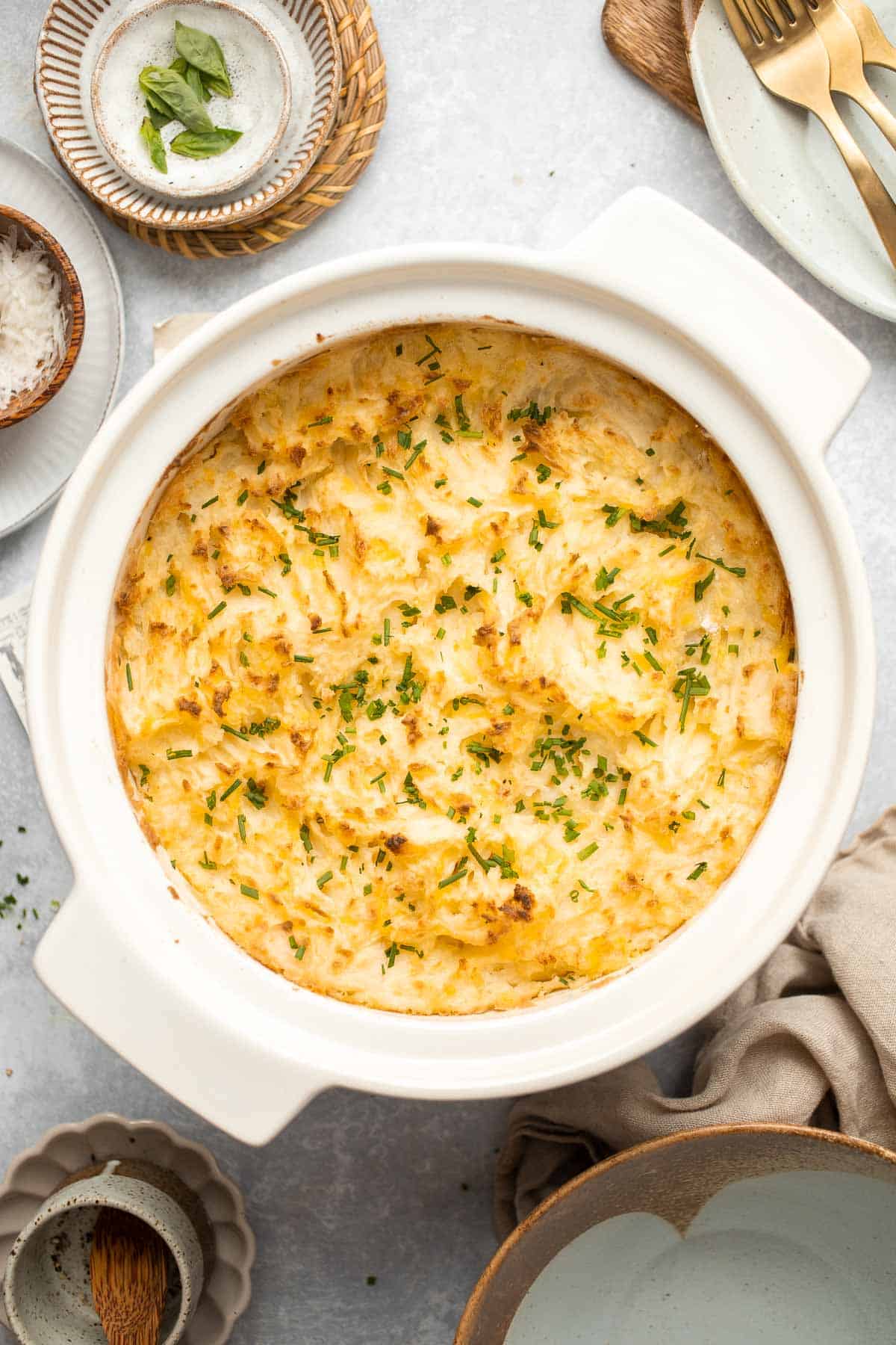 Baked Mashed Potatoes are buttery, cheesy, and crispy on the outside. Topped with chives and served warm, this side dish that will change your hosting game. | aheadofthyme.com 