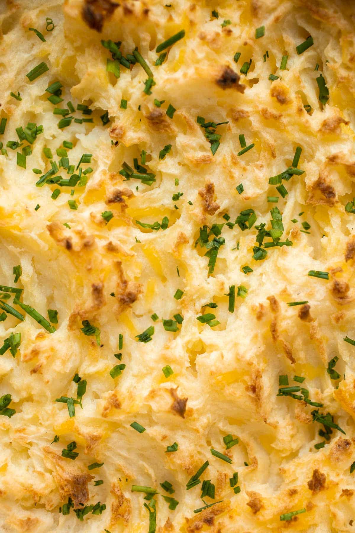 Baked Mashed Potatoes are buttery, cheesy, and crispy on the outside. Topped with chives and served warm, this side dish that will change your hosting game. | aheadofthyme.com