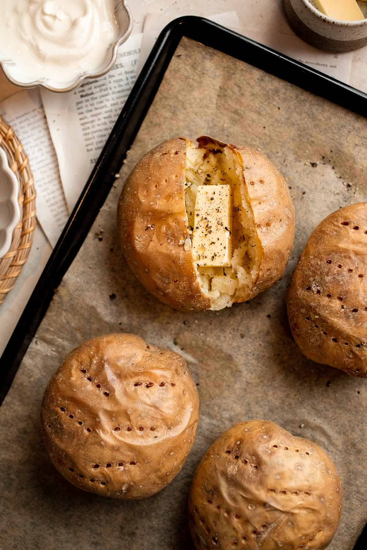 This Baked Potato is a delicious, hearty side dish that pairs well with any main course. It's fluffy and creamy inside, and golden brown and crispy outside. | aheadofthyme.com