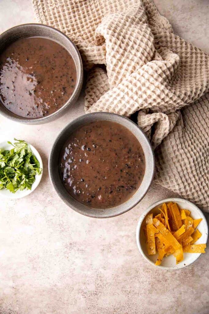 This Black Bean Soup is hearty, healthy, and cozy — everything you want in a soup! It's loaded with black beans, spices, and your favorite Mexican toppings. | aheadofthyme.com