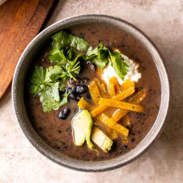 This Black Bean Soup is hearty, healthy, and cozy — everything you want in a soup! It's loaded with black beans, spices, and your favorite Mexican toppings. | aheadofthyme.com