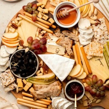 This easy Cheese Board is a popular and classic appetizer arranged with an assortment of cheese, bread and crackers, fresh fruit, and nuts. | aheadofthyme.com