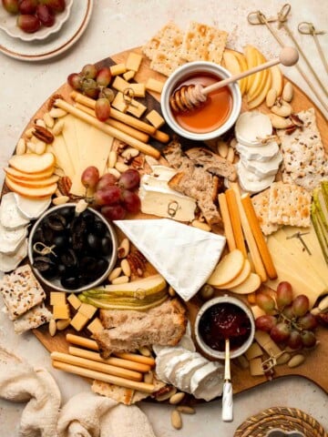 This easy Cheese Board is a popular and classic appetizer arranged with an assortment of cheese, bread and crackers, fresh fruit, and nuts. | aheadofthyme.com