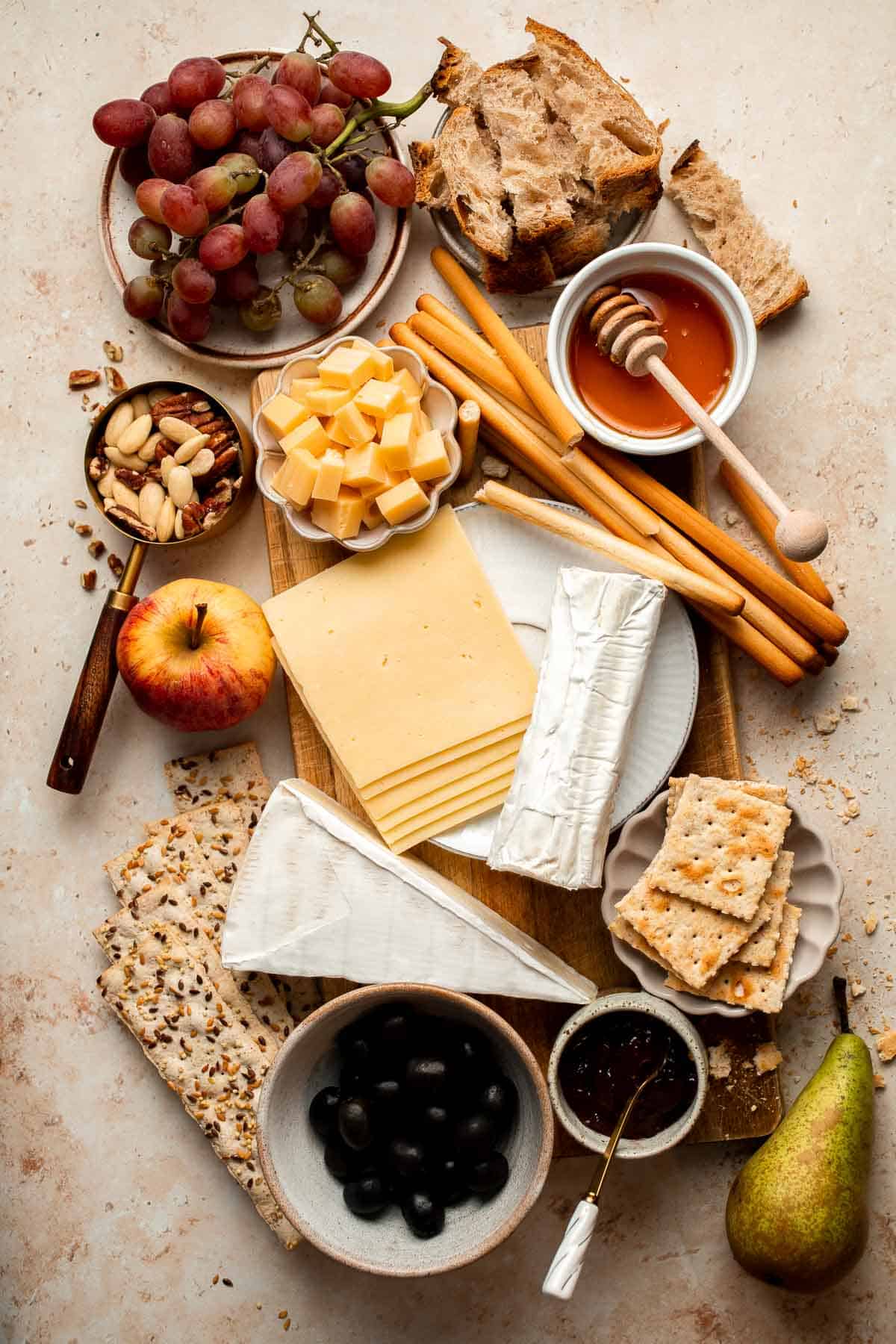 This easy Cheese Board is a popular and classic appetizer arranged with an assortment of cheese, bread and crackers, fresh fruit, and nuts. | aheadofthyme.com