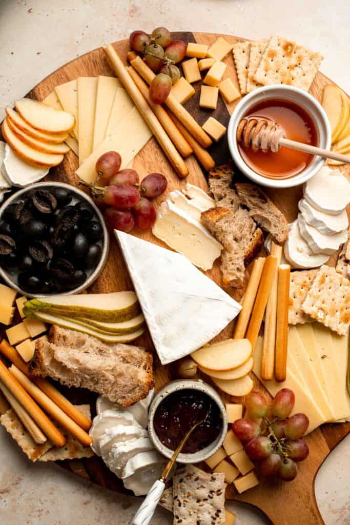 This easy Cheese Board is a popular and classic appetizer arranged with an assortment of cheese, bread and crackers, fresh fruit, and nuts. | aheadofthyme.com