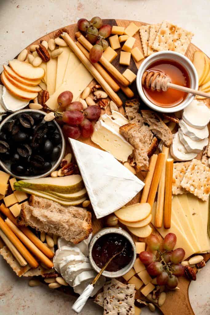 This easy Cheese Board is a popular and classic appetizer arranged with an assortment of cheese, bread and crackers, fresh fruit, and nuts. | aheadofthyme.com