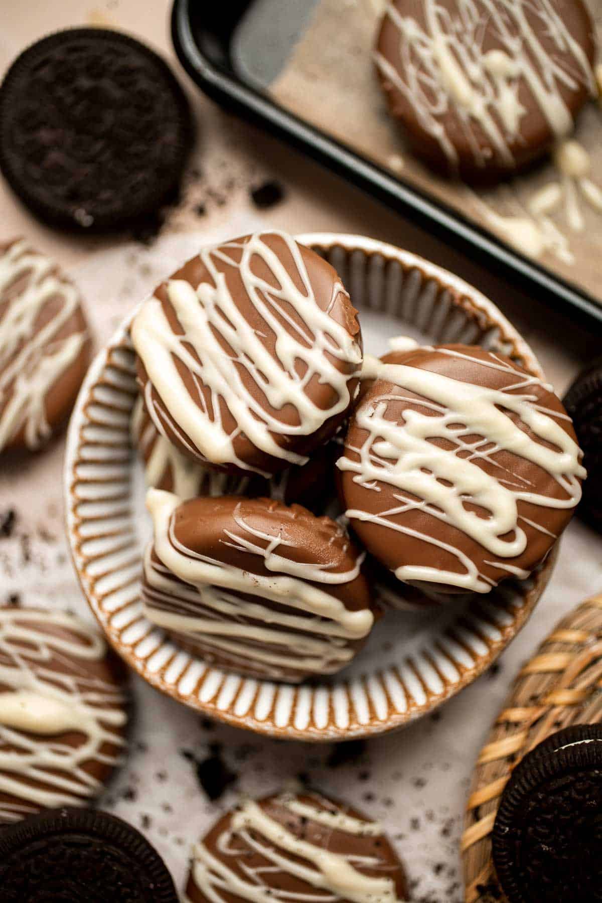 Chocolate Covered Oreos are a perfect last minute treat! Level up regular Oreos with a layer of semi-sweet chocolate and a white chocolate drizzle on top. | aheadofthyme.com