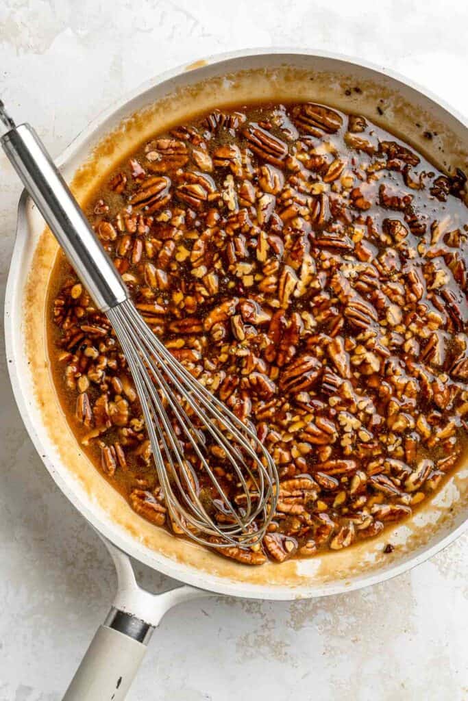Pecan Pie Cheesecake takes a classic flavor to a new level with a pecan graham cracker crust, brown sugar cheesecake filling, and caramel pecan pie topping. | aheadofthyme.com