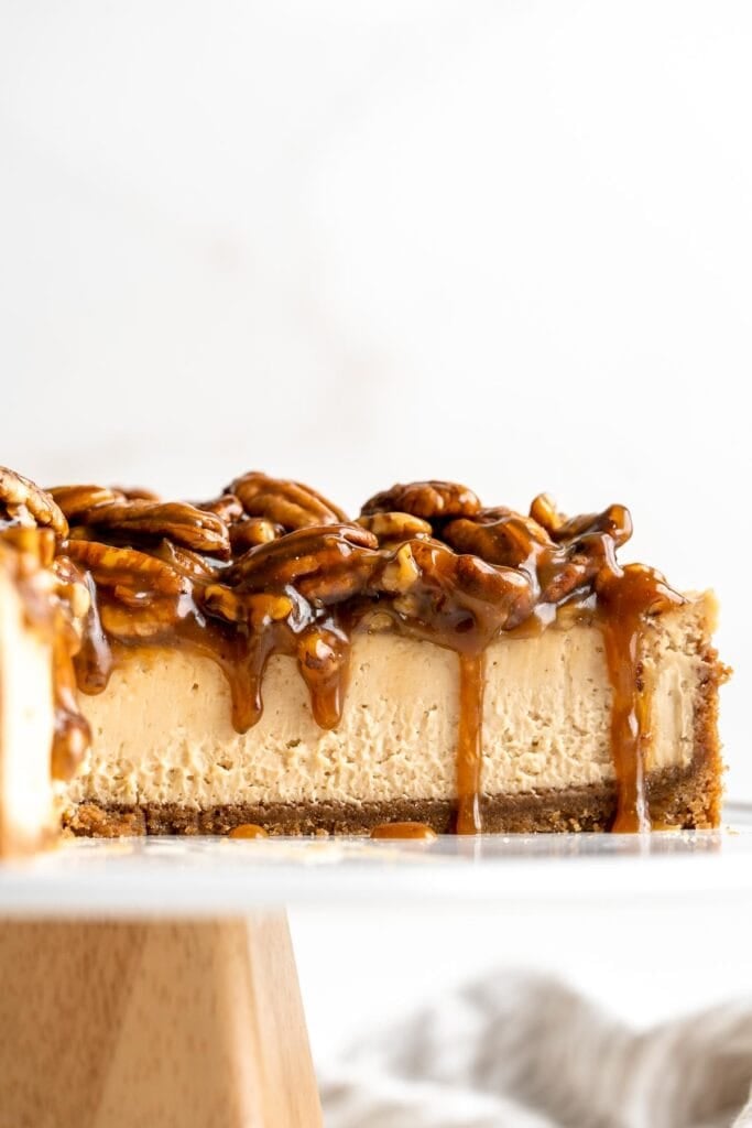 Pecan Pie Cheesecake takes a classic flavor to a new level with a pecan graham cracker crust, brown sugar cheesecake filling, and caramel pecan pie topping. | aheadofthyme.com