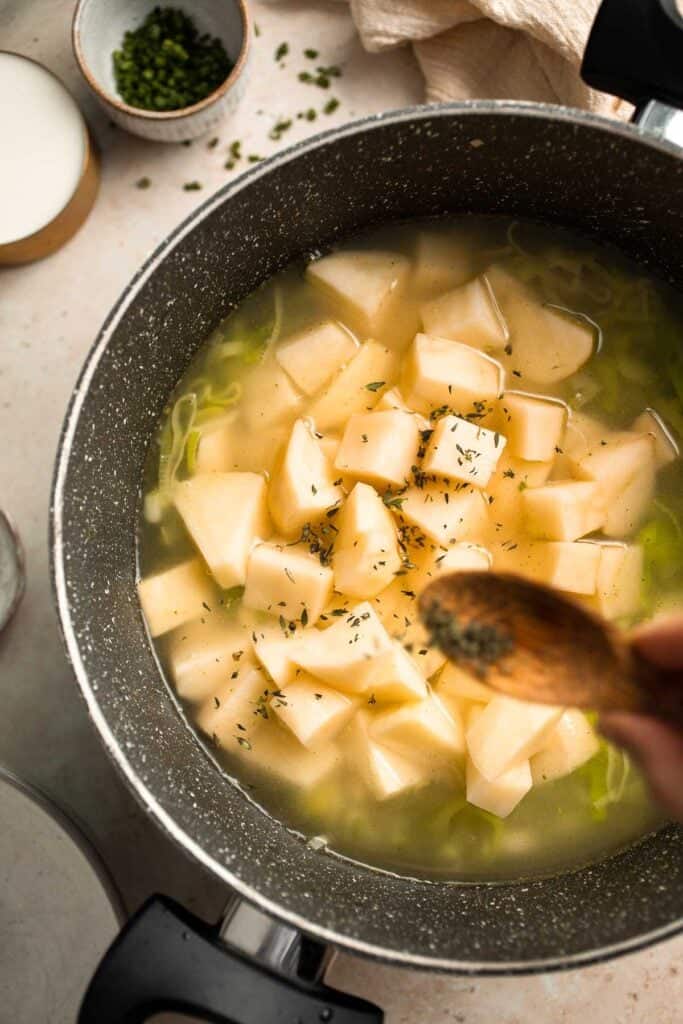 This Potato Leek Soup recipe is a classic for good reason! This creamy and velvety soup is quick and easy to make in 30 minutes using 8 ingredients. | aheadofthyme.com