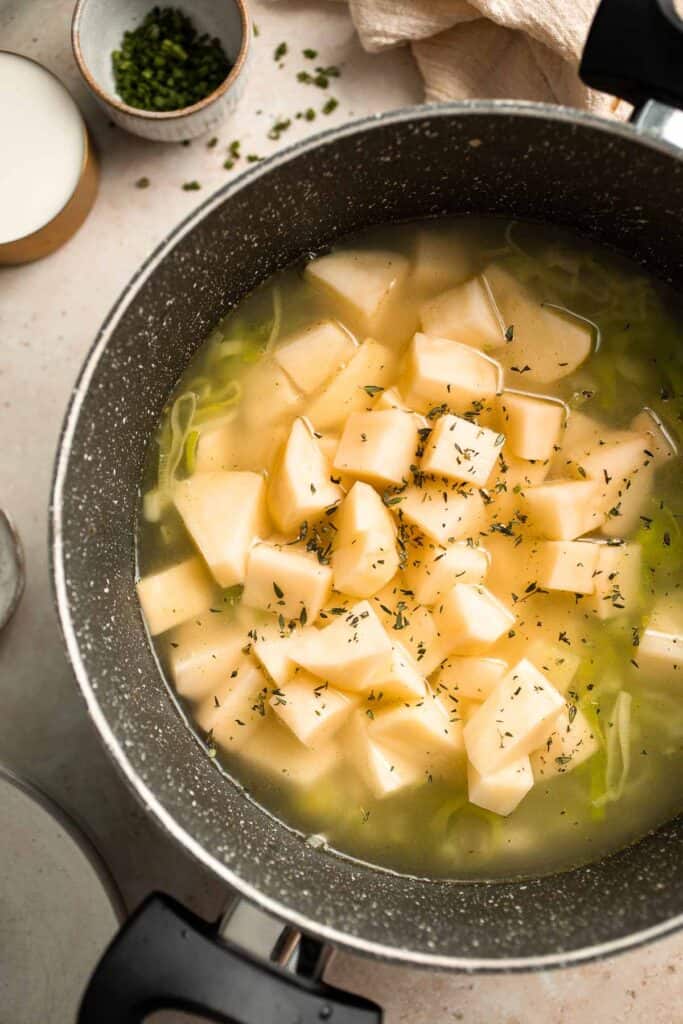 This Potato Leek Soup recipe is a classic for good reason! This creamy and velvety soup is quick and easy to make in 30 minutes using 8 ingredients. | aheadofthyme.com