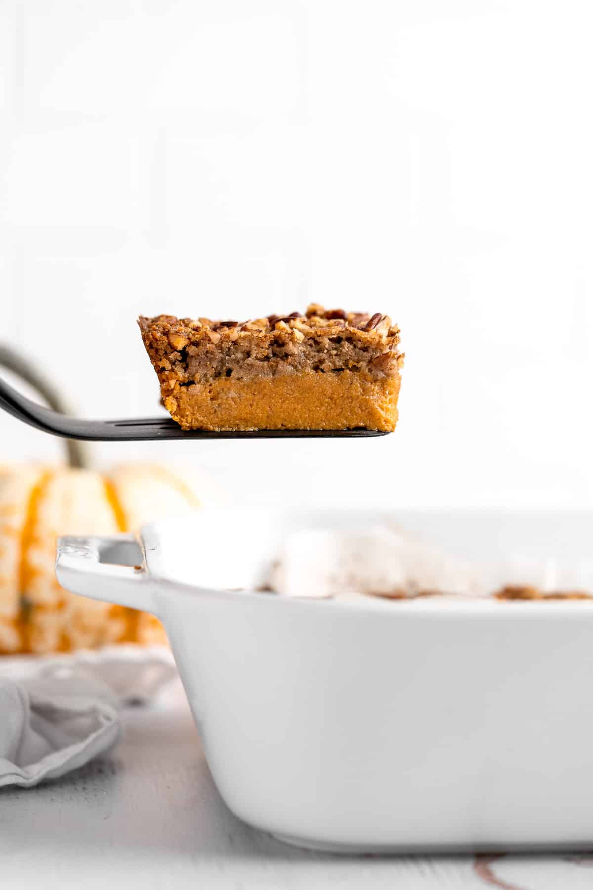 This easy Pumpkin Dump Cake recipe is loaded with fall flavors from the homemade pumpkin pie filling topped with spice cake mix and pecans. | aheadofthyme.com