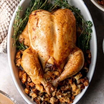 Roast Stuffed Chicken is easy to make and has everything you need for a meal in one pan. Serve it for a special occasion or weekly for Sunday roast dinner. | aheadofthyme.com