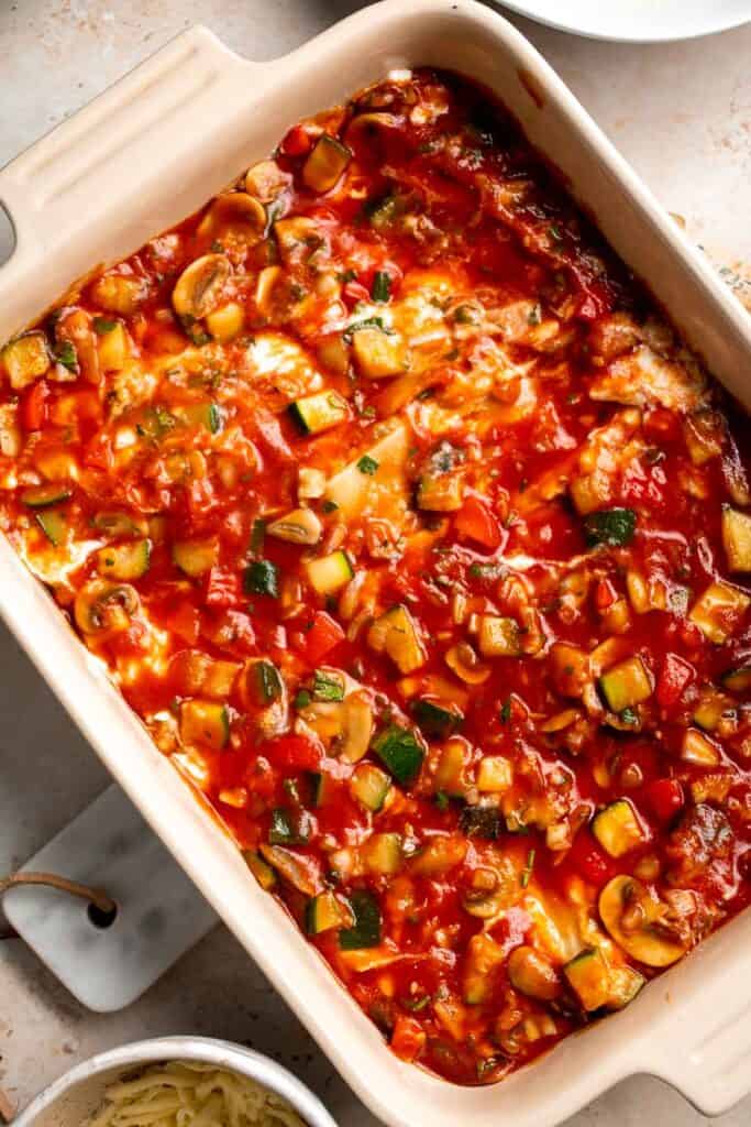 This Vegetable Lasagna is a hearty meatless dish layered with perfectly al dente noodles, rich tomato sauce with veggies, and a creamy three-cheese mixture. | aheadofthyme.com