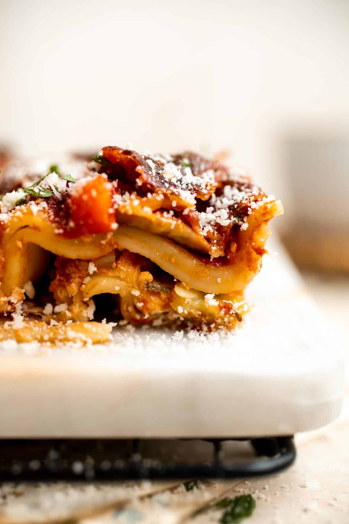 This Vegetable Lasagna is a hearty meatless dish layered with perfectly al dente noodles, rich tomato sauce with veggies, and a creamy three-cheese mixture. | aheadofthyme.com