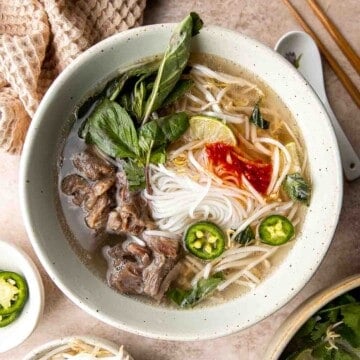 Vietnamese Pho is a one-of-a-kind soup known for its aromatic beef broth served over tender rice noodles, beef sirloin, fresh herbs, and other garnishes. | aheadofthyme.com